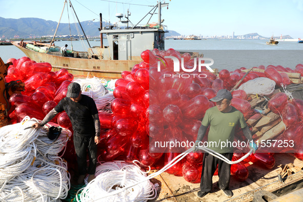 Fishermen load a floating ship to be transported to a breeding area in Lianyungang, China, on September 8, 2024. 