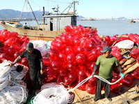 Fishermen load a floating ship to be transported to a breeding area in Lianyungang, China, on September 8, 2024. (