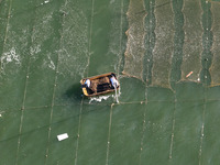 Fishermen drive various kinds of aquaculture boats in the coastal aquaculture zone in Lianyungang, China, on September 8, 2024. (