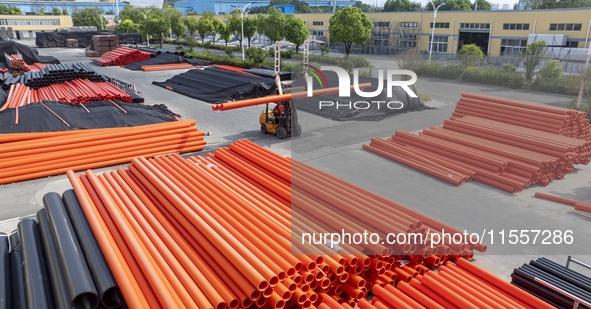 A worker produces pipes at a production workshop in Suqian, China, on September 8, 2024. 