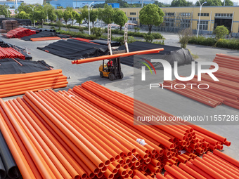 A worker produces pipes at a production workshop in Suqian, China, on September 8, 2024. (