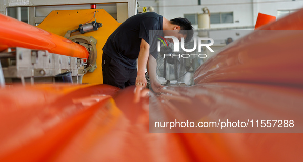 A worker produces pipes at a production workshop in Suqian, China, on September 8, 2024. 