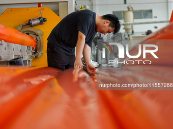 A worker produces pipes at a production workshop in Suqian, China, on September 8, 2024. (