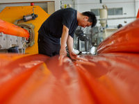 A worker produces pipes at a production workshop in Suqian, China, on September 8, 2024. (