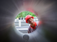 A worker produces pipes at a production workshop in Suqian, China, on September 8, 2024. (