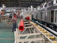 A worker produces pipes at a production workshop in Suqian, China, on September 8, 2024. (