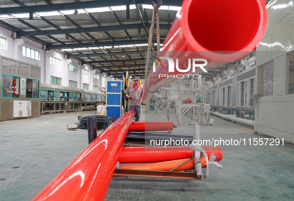 A worker produces pipes at a production workshop in Suqian, China, on September 8, 2024. 