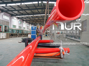 A worker produces pipes at a production workshop in Suqian, China, on September 8, 2024. (