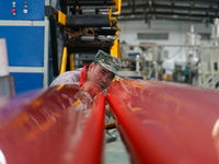 A worker produces pipes at a production workshop in Suqian, China, on September 8, 2024. (