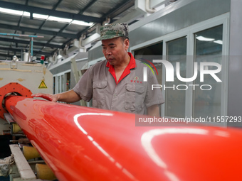 A worker produces pipes at a production workshop in Suqian, China, on September 8, 2024. (