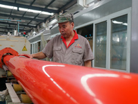 A worker produces pipes at a production workshop in Suqian, China, on September 8, 2024. (