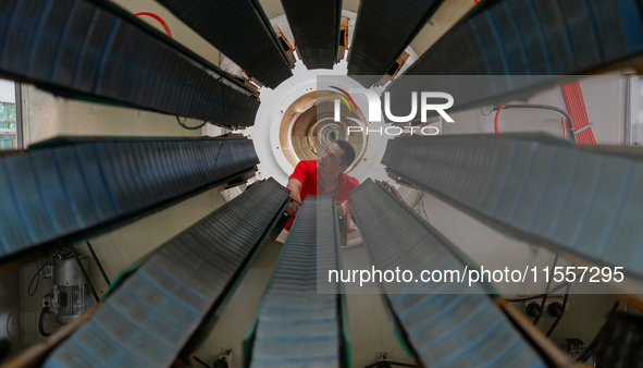 A worker produces pipes at a production workshop in Suqian, China, on September 8, 2024. 