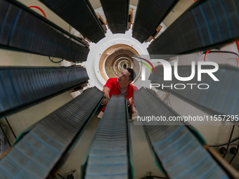 A worker produces pipes at a production workshop in Suqian, China, on September 8, 2024. (