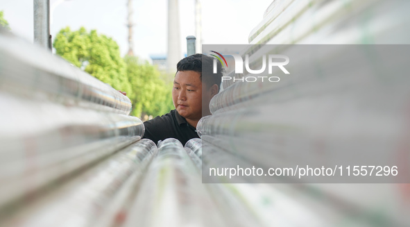 A worker produces pipes at a production workshop in Suqian, China, on September 8, 2024. 