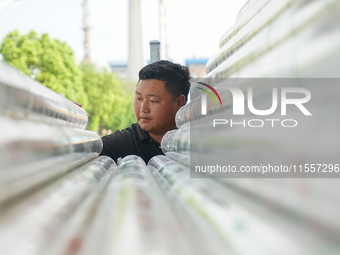 A worker produces pipes at a production workshop in Suqian, China, on September 8, 2024. (