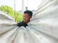 A worker produces pipes at a production workshop in Suqian, China, on September 8, 2024. (