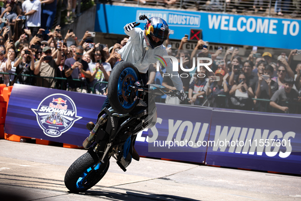 Aaron Colton performs motorcycle tricks during a Red Bull Showrun in Houston, Texas, on September 7, 2024. 