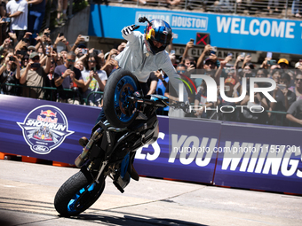 Aaron Colton performs motorcycle tricks during a Red Bull Showrun in Houston, Texas, on September 7, 2024. (