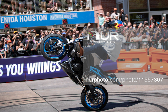 Aaron Colton performs motorcycle tricks during a Red Bull Showrun in Houston, Texas, on September 7, 2024. 