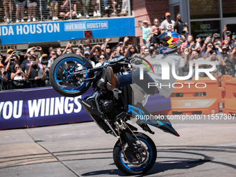 Aaron Colton performs motorcycle tricks during a Red Bull Showrun in Houston, Texas, on September 7, 2024. (