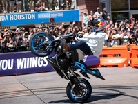 Aaron Colton performs motorcycle tricks during a Red Bull Showrun in Houston, Texas, on September 7, 2024. (