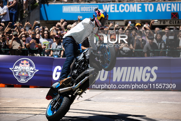 Aaron Colton performs motorcycle tricks during a Red Bull Showrun in Houston, Texas, on September 7, 2024. 