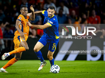 Netherlands midfielder Ryan Gravenberch and Bosnia and Herzegovina defender Adrian Leon Barisic during the match between the Netherlands and...