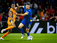 Netherlands midfielder Ryan Gravenberch and Bosnia and Herzegovina defender Adrian Leon Barisic during the match between the Netherlands and...