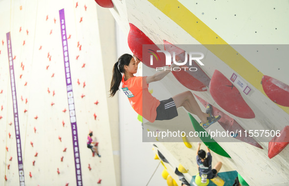 Contestants take part in a rock climbing competition at the indoor climbing gym of Anlong National Mountain Outdoor Sports Demonstration Par...