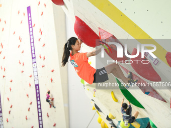 Contestants take part in a rock climbing competition at the indoor climbing gym of Anlong National Mountain Outdoor Sports Demonstration Par...