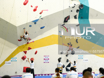 Contestants take part in a rock climbing competition at the indoor climbing gym of Anlong National Mountain Outdoor Sports Demonstration Par...