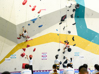 Contestants take part in a rock climbing competition at the indoor climbing gym of Anlong National Mountain Outdoor Sports Demonstration Par...