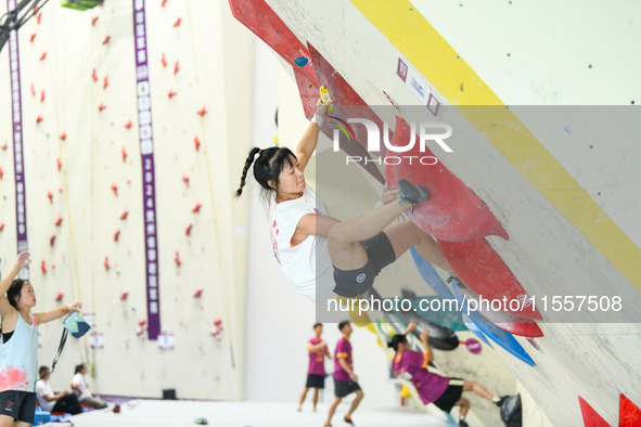 Contestants take part in a rock climbing competition at the indoor climbing gym of Anlong National Mountain Outdoor Sports Demonstration Par...