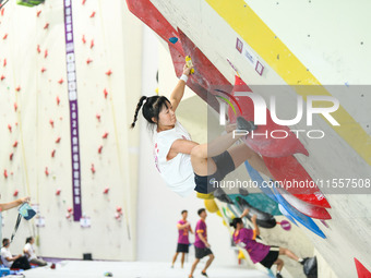 Contestants take part in a rock climbing competition at the indoor climbing gym of Anlong National Mountain Outdoor Sports Demonstration Par...