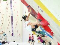 Contestants take part in a rock climbing competition at the indoor climbing gym of Anlong National Mountain Outdoor Sports Demonstration Par...