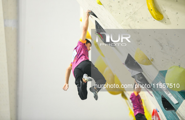 Contestants take part in a rock climbing competition at the indoor climbing gym of Anlong National Mountain Outdoor Sports Demonstration Par...