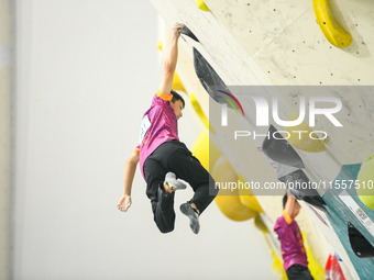 Contestants take part in a rock climbing competition at the indoor climbing gym of Anlong National Mountain Outdoor Sports Demonstration Par...