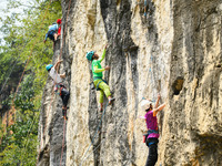 Contestants compete in the Red Dot competition at the Natural Rock Wall of Anlong National Mountain Outdoor Sports Demonstration Park in Qia...