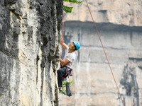 Contestants compete in the Red Dot competition at the Natural Rock Wall of Anlong National Mountain Outdoor Sports Demonstration Park in Qia...