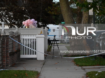 Crime scene investigators place evidence markers at the scene where three people are shot at 132-45 220th Street in Queens, New York, United...