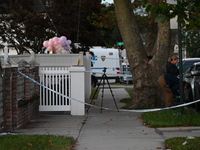 Crime scene investigators place evidence markers at the scene where three people are shot at 132-45 220th Street in Queens, New York, United...