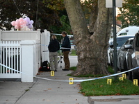 Crime scene investigators place evidence markers at the scene where three people are shot at 132-45 220th Street in Queens, New York, United...