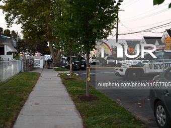 Crime scene investigators place evidence markers at the scene where three people are shot at 132-45 220th Street in Queens, New York, United...