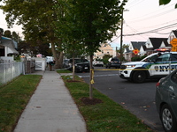 Crime scene investigators place evidence markers at the scene where three people are shot at 132-45 220th Street in Queens, New York, United...