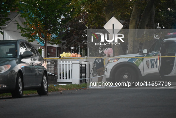 Crime scene investigators place evidence markers at the scene where three people are shot at 132-45 220th Street in Queens, New York, United...