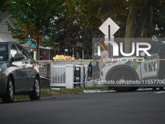 Crime scene investigators place evidence markers at the scene where three people are shot at 132-45 220th Street in Queens, New York, United...