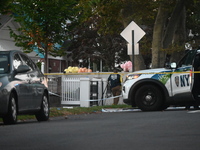 Crime scene investigators place evidence markers at the scene where three people are shot at 132-45 220th Street in Queens, New York, United...