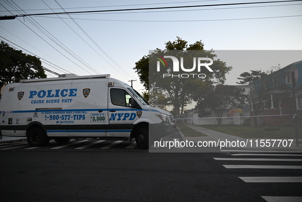 Crime scene investigators place evidence markers at the scene where three people are shot at 132-45 220th Street in Queens, New York, United...