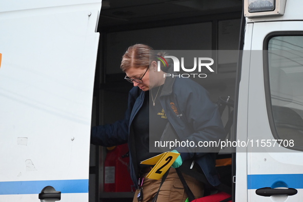 Crime scene investigators place evidence markers at the scene where three people are shot at 132-45 220th Street in Queens, New York, United...