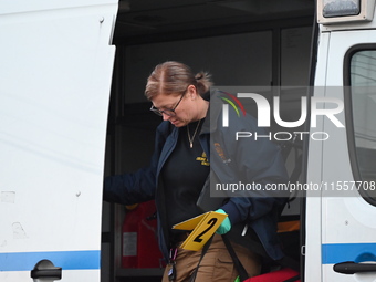 Crime scene investigators place evidence markers at the scene where three people are shot at 132-45 220th Street in Queens, New York, United...